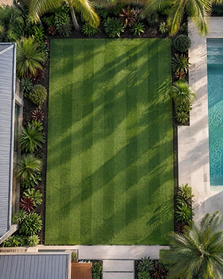 Overhead view of a striped lawn with crisp edges and garden beds